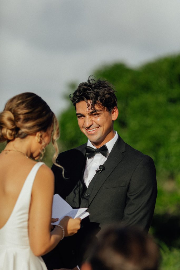 Kyler laughing during Rebecca's vows