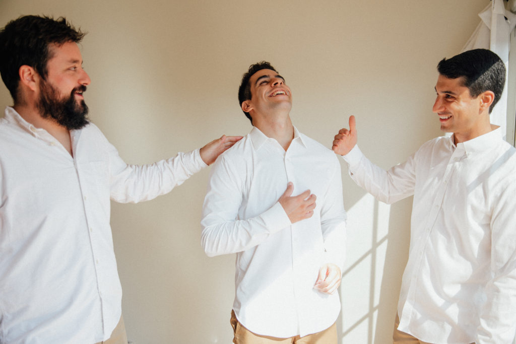 Mike laughing with her groomsmen as they get ready