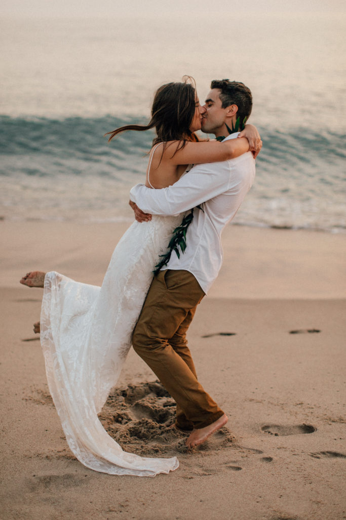 The couple kissing on the beach